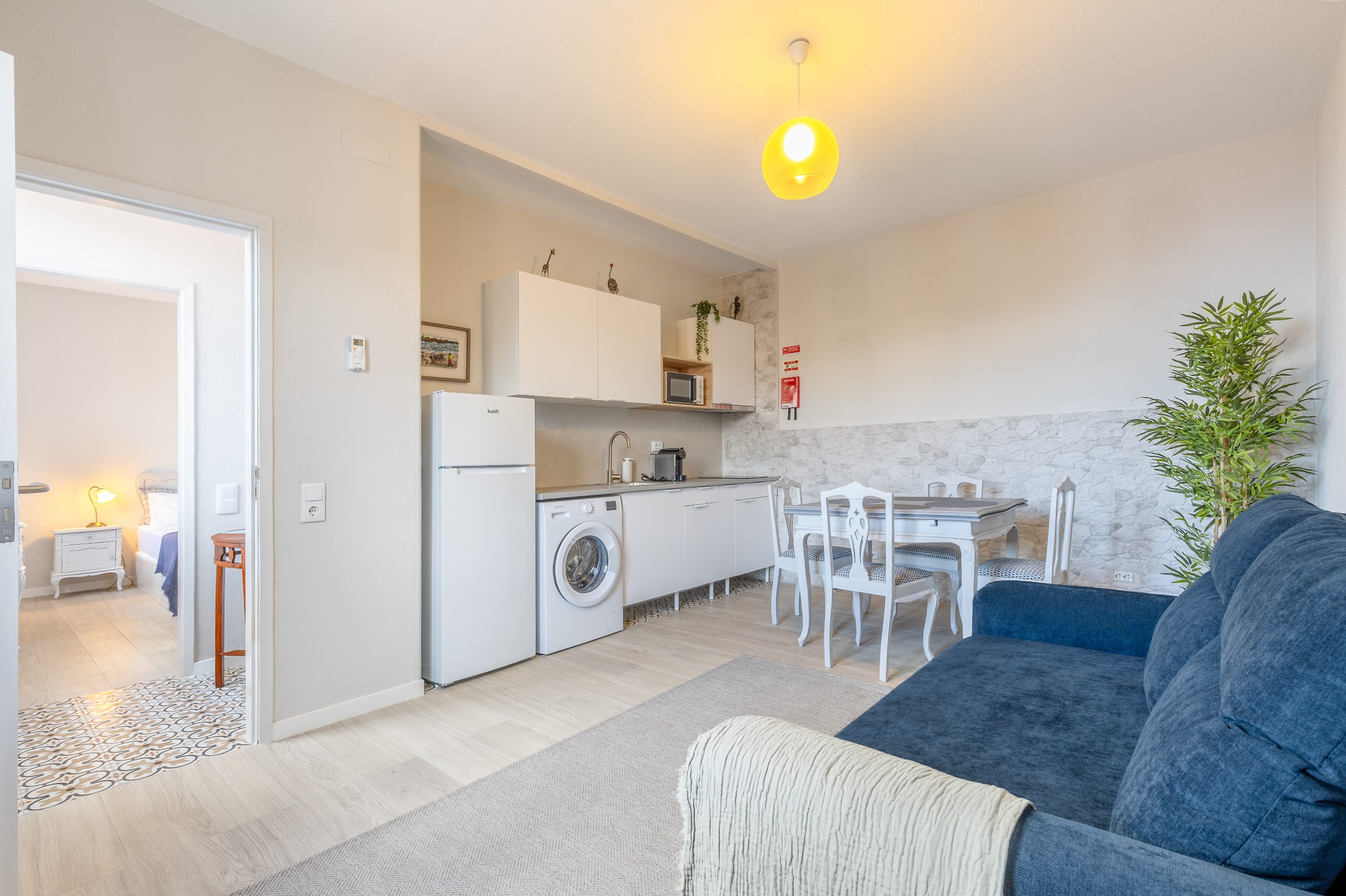 Open living space with sofa, dining table and kitchen